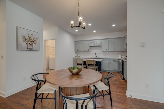 dining area with recessed lighting, baseboards, dark wood-style floors, washer / clothes dryer, and an inviting chandelier