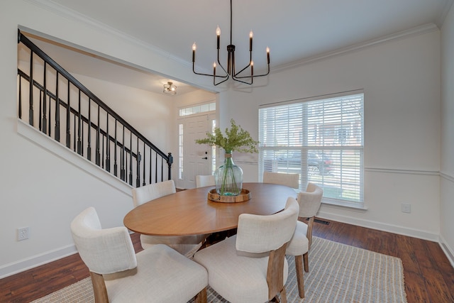 dining room with baseboards, ornamental molding, and wood finished floors