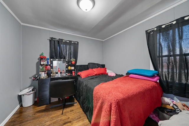 bedroom featuring crown molding and wood finished floors