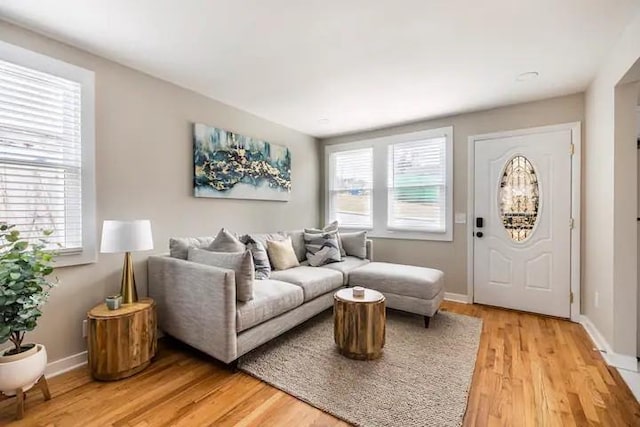 living room featuring light wood finished floors and baseboards