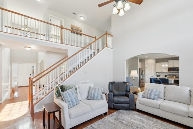 806 Warrington Ct, Gallatin, TN 37066 - living area featuring stairway, wood finished floors, baseboards, arched walkways, and ceiling fan