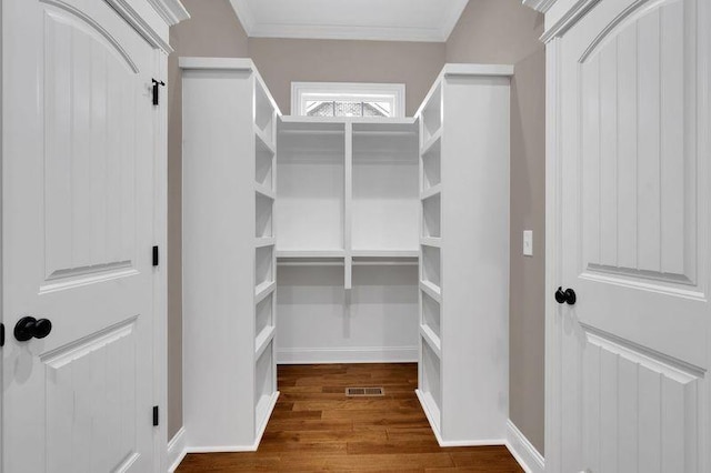 spacious closet featuring dark wood-style floors and visible vents