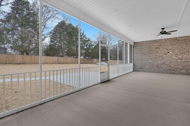 unfurnished sunroom with a ceiling fan