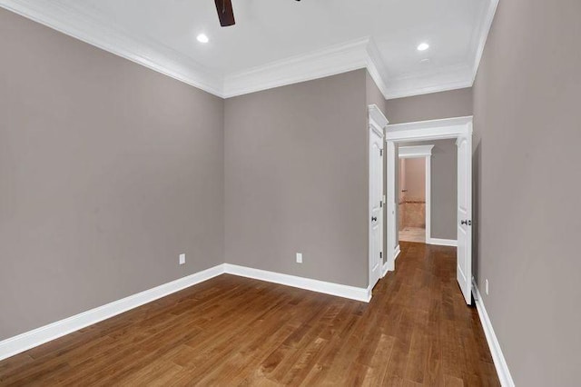 unfurnished room with crown molding, wood finished floors, a ceiling fan, and baseboards