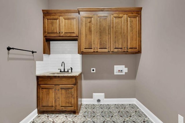 laundry area with hookup for a washing machine, a sink, baseboards, cabinet space, and electric dryer hookup