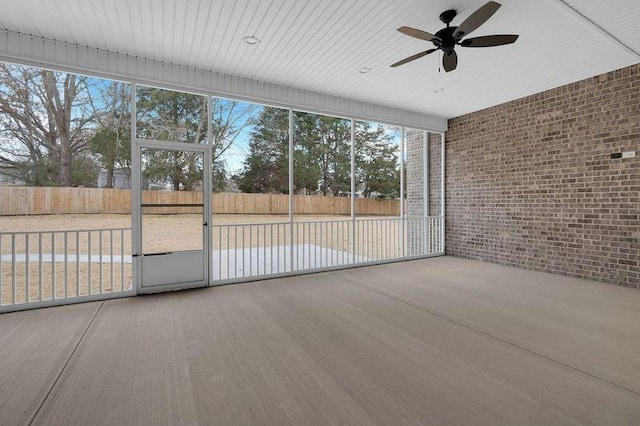 unfurnished sunroom with ceiling fan