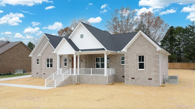 view of front of home featuring crawl space, covered porch, brick siding, and central air condition unit