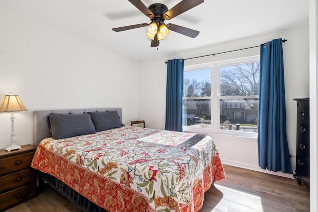 bedroom with a ceiling fan and wood finished floors