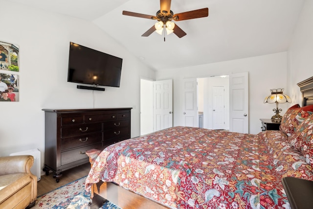 bedroom featuring ceiling fan, vaulted ceiling, and wood finished floors