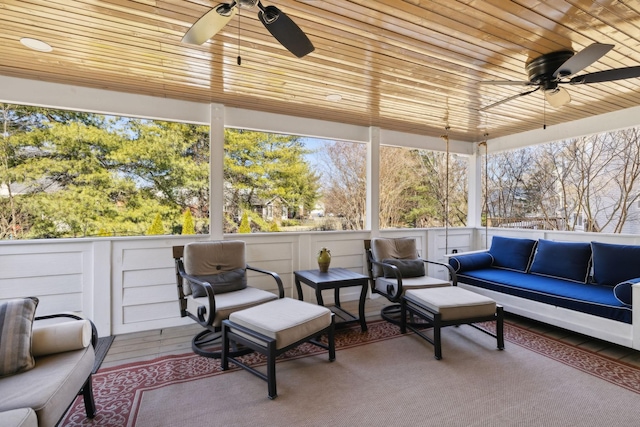 sunroom with wooden ceiling and ceiling fan