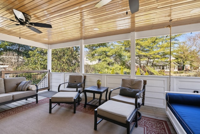 sunroom with wooden ceiling and ceiling fan