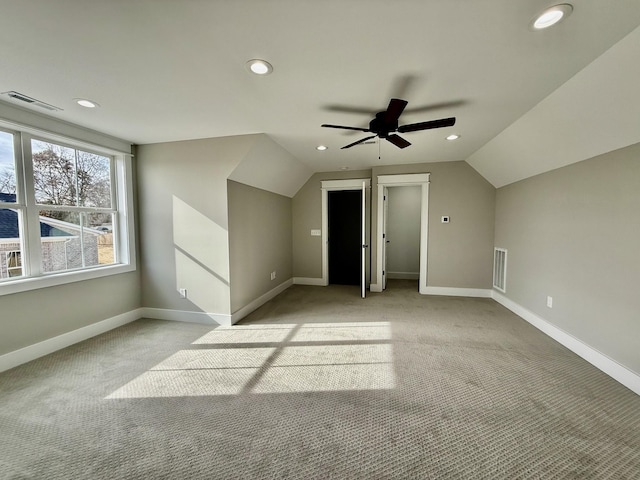 additional living space with lofted ceiling, baseboards, visible vents, and recessed lighting