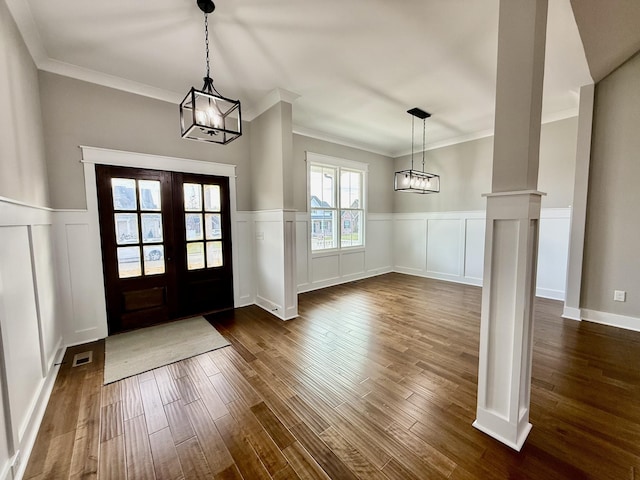 entrance foyer featuring french doors, dark wood-style flooring, visible vents, and ornate columns