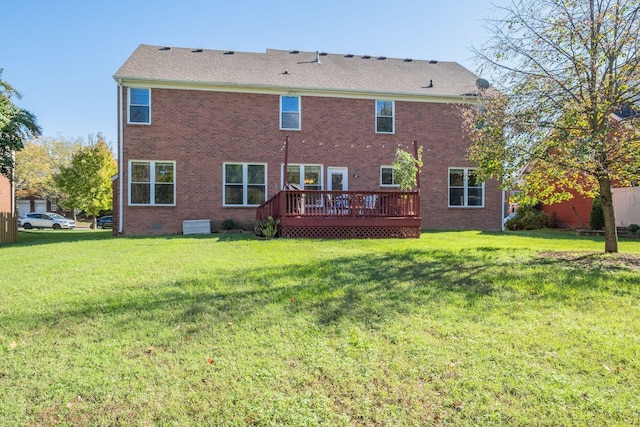 back of property featuring brick siding, crawl space, a wooden deck, and a lawn