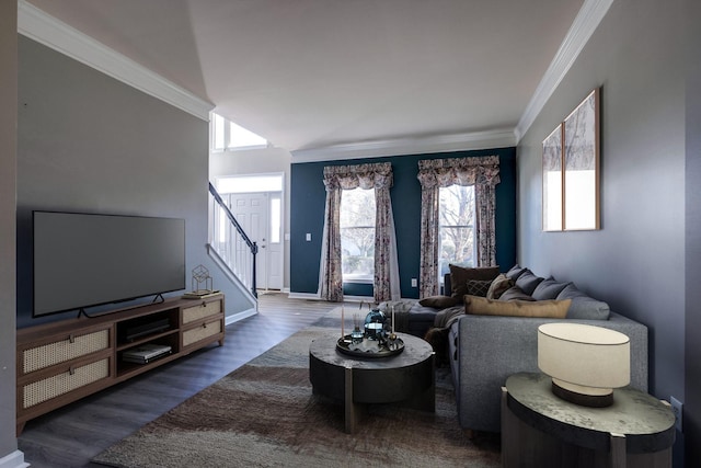 living room with stairs, baseboards, wood finished floors, and crown molding