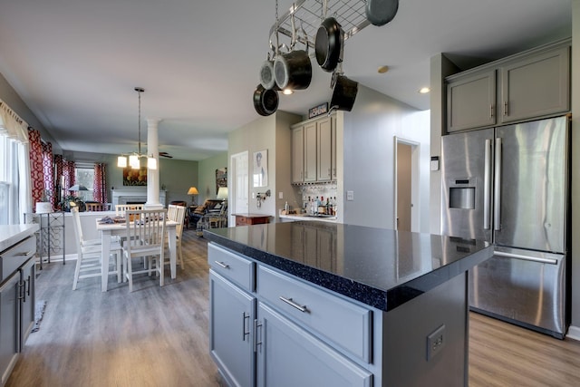 kitchen with light wood-style floors, stainless steel refrigerator with ice dispenser, and gray cabinetry