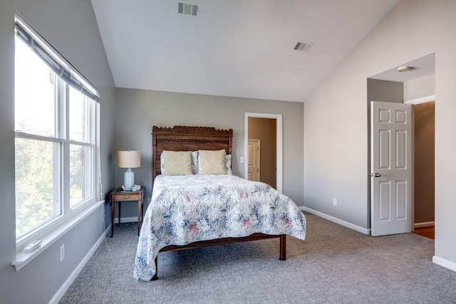 carpeted bedroom with lofted ceiling, visible vents, and baseboards