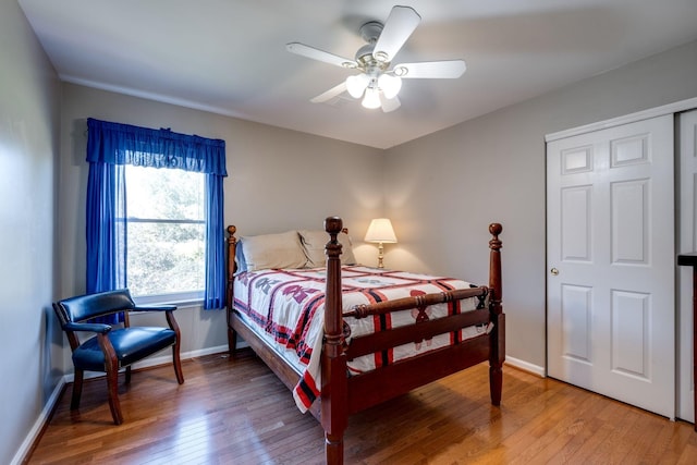 bedroom featuring a ceiling fan, baseboards, and light wood finished floors