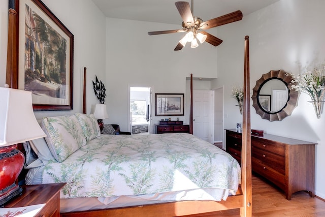 bedroom with a towering ceiling and light wood-style flooring