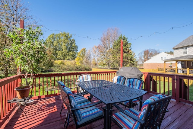 wooden deck featuring outdoor dining area and grilling area