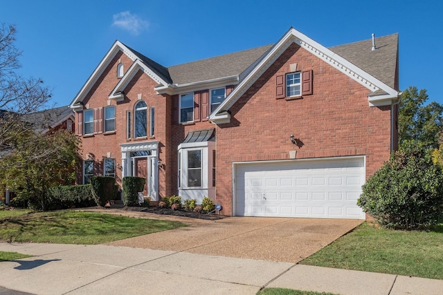 view of front of property with a garage, driveway, brick siding, and a front lawn