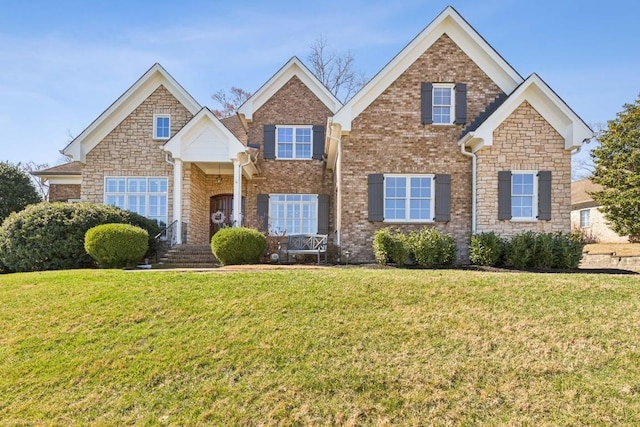 traditional home with a front yard and brick siding