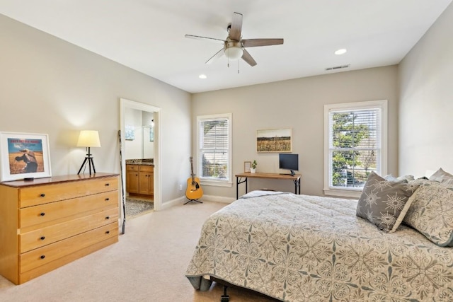 bedroom with recessed lighting, visible vents, ensuite bathroom, light carpet, and baseboards