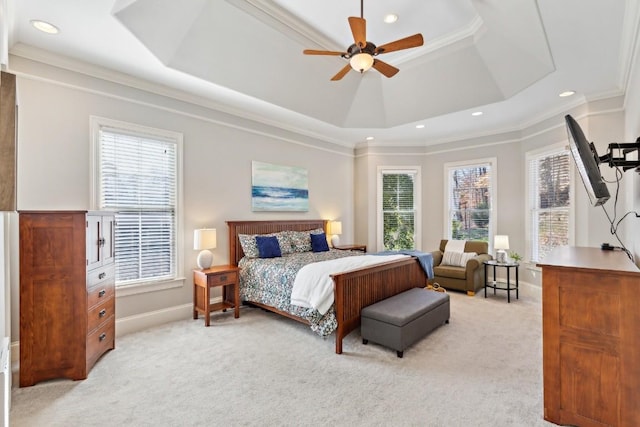 bedroom with light carpet, a tray ceiling, ornamental molding, and baseboards