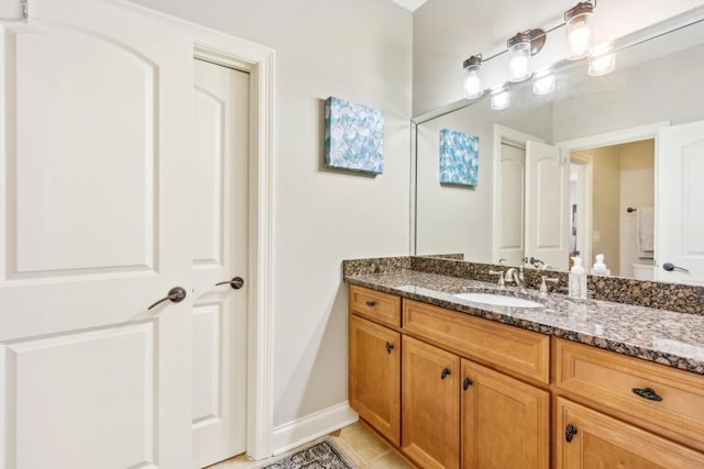 bathroom featuring baseboards and vanity