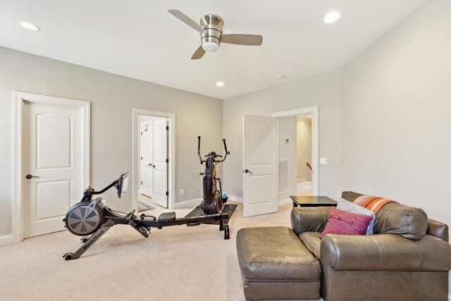 workout room with recessed lighting and light carpet