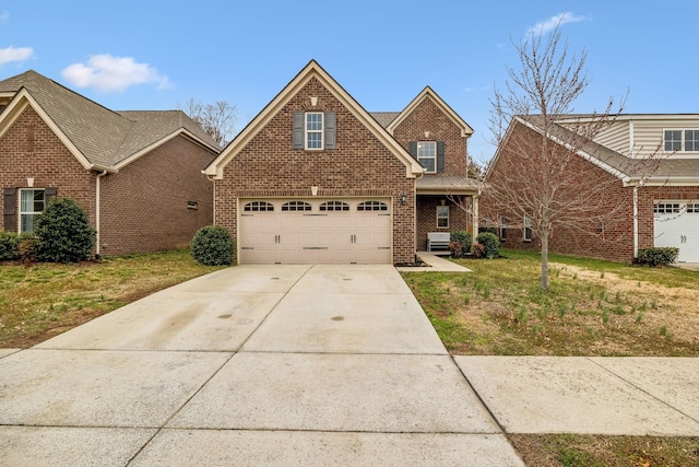 traditional-style home featuring driveway, a front yard, and brick siding