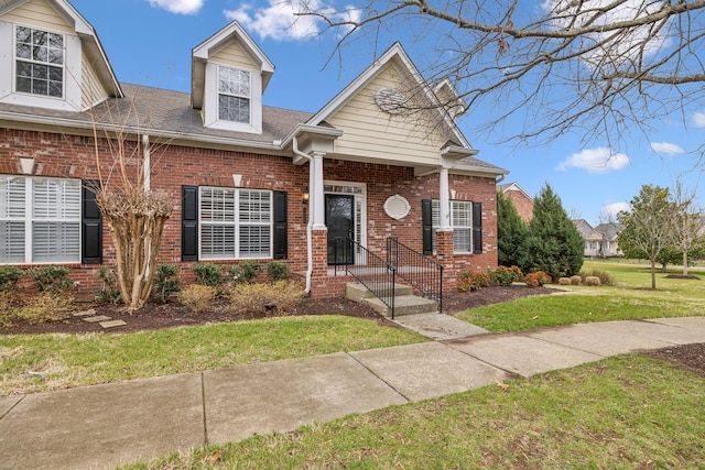 view of front of property with brick siding and a front yard