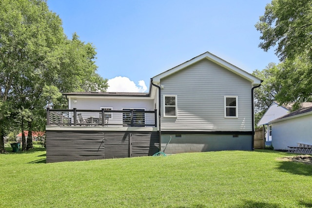 back of house featuring crawl space, a lawn, and a wooden deck