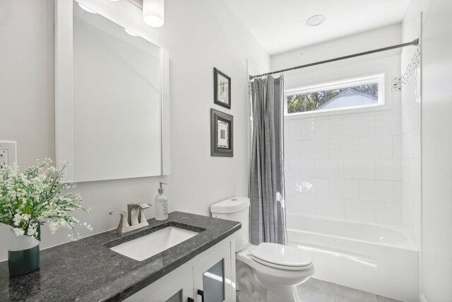 full bathroom featuring shower / bathtub combination with curtain, vanity, toilet, and tile patterned floors