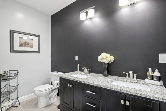 bathroom featuring tile patterned flooring, a sink, toilet, and baseboards