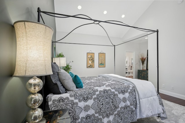 bedroom featuring vaulted ceiling, baseboards, wood finished floors, and recessed lighting