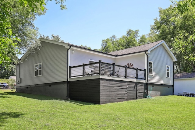 rear view of property with crawl space, a lawn, and a wooden deck