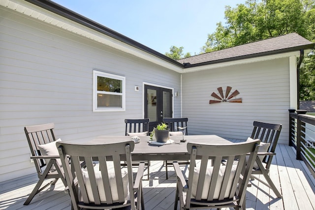 wooden deck featuring outdoor dining area and french doors