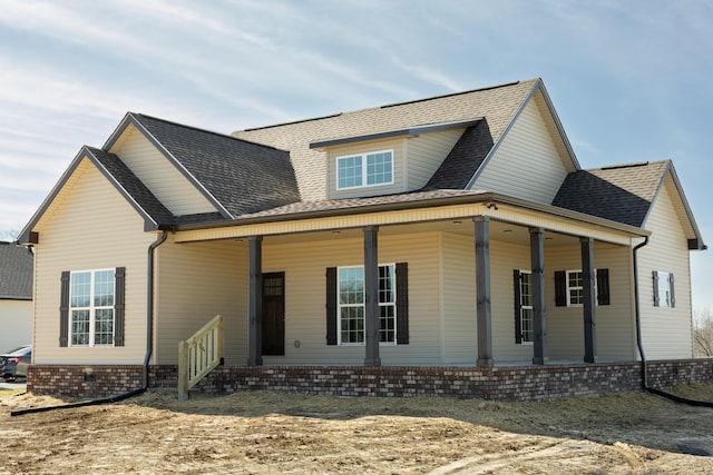 view of front of property featuring covered porch and roof with shingles