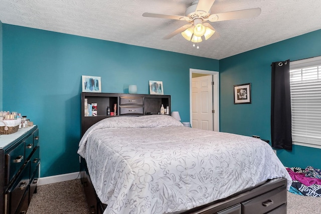 carpeted bedroom with a ceiling fan, baseboards, and a textured ceiling