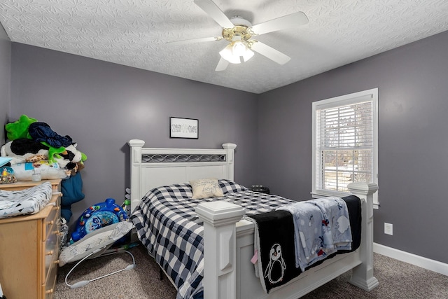 carpeted bedroom with ceiling fan, a textured ceiling, and baseboards