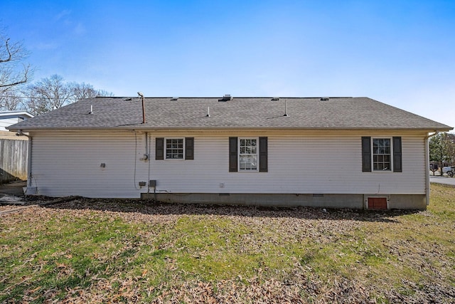 back of property featuring a shingled roof, crawl space, and a yard