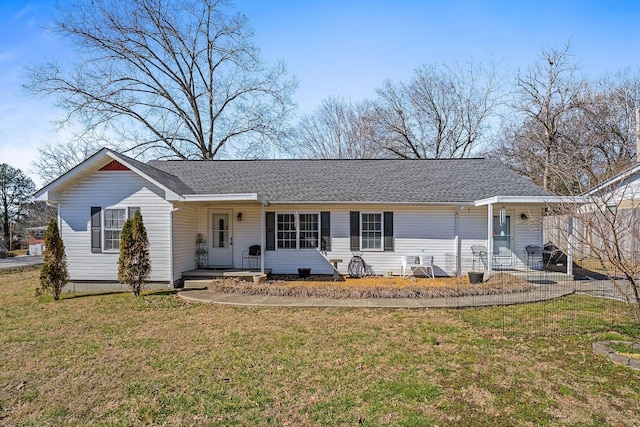 ranch-style house with a shingled roof and a front lawn