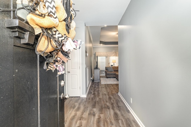 hallway with wood finished floors and baseboards