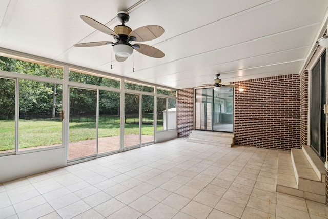 unfurnished sunroom with ceiling fan