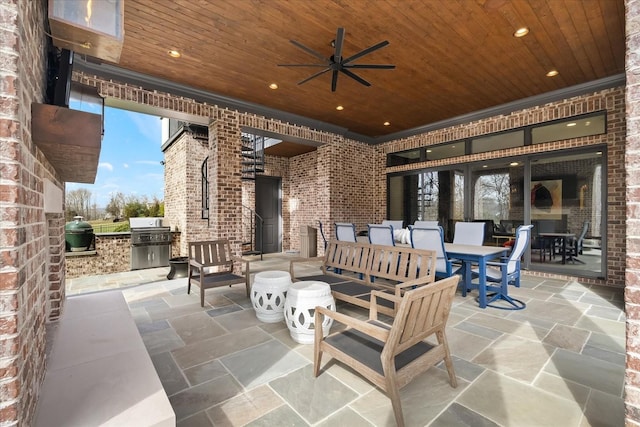 view of patio featuring outdoor dining area, a ceiling fan, and area for grilling