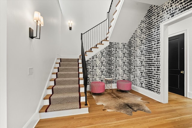 staircase with wood finished floors and baseboards