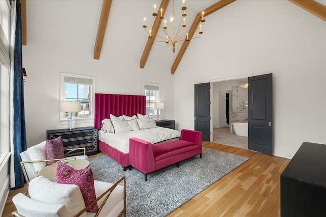 bedroom featuring a chandelier, high vaulted ceiling, wood finished floors, baseboards, and beam ceiling