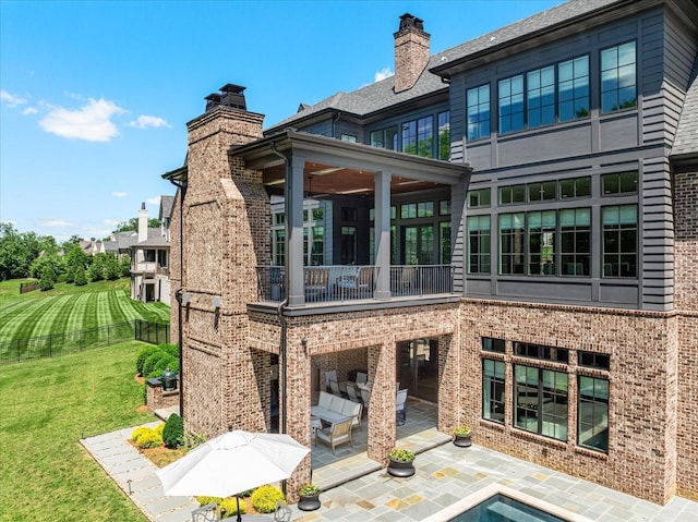 9289 Fordham Dr, Brentwood, TN 37027 - rear view of house with a patio, a balcony, a yard, a chimney, and brick siding