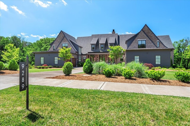 9289 Fordham Dr, Brentwood, TN 37027 - view of front of home with a front lawn, a chimney, and driveway